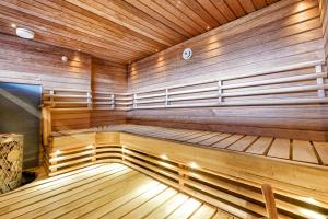 a large wooden sauna with wooden floors and ceilings at Villa Solarsuite Incl WiFi, Jacuzzi for extra fee in Himos