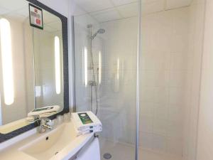a bathroom with a shower and a sink at ibis Dunkerque in Dunkerque +41 photos
