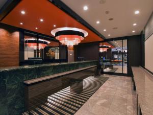 a bar in a restaurant with lights and mirrors at APA Hotel Gifu Hashima Ekimae in Hashima