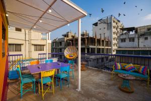 a patio with a table and chairs on a balcony at goSTOPS Bengaluru, Gandhi Nagar Majestic - Private Rooms & Dorms in Bangalore