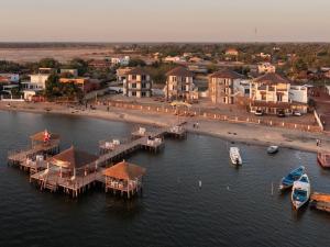 an aerial view of a harbor with boats in the water at Hotel Cap du Sine Saloum in Ndangane
