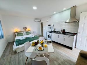 a room with a bed and a table with fruit on it at ALAUDAE Apartamentos Parking Gratis plazas limitadas in Mérida +43 photos