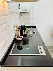 a kitchen counter with a sink and a mixer at ALAUDAE Apartamentos Parking Gratis plazas limitadas in Mérida