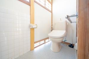 a bathroom with a white toilet in a room at Wakamizu Minpaku in Tōgane