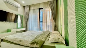 a bedroom with a bed in front of a window at Vinsmart City Cam Cam homestay in Phú Thú