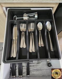 a tray of utensils in a drawer at Simpsons Little Gem 2 in Kingston