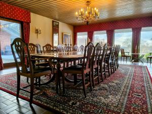 a dining room with a long table and chairs at Sæbygaard Estate Kalundborg in Ruds-Vedby