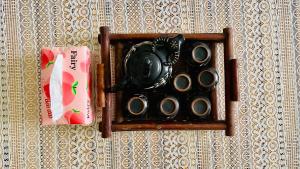 a wall with a wooden holder with a tea pot at Vinsmart City Cam Cam homestay in Phú Thú +8 photos
