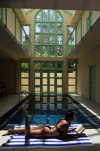 a woman laying on a mat in a swimming pool at Allude Villa Weligama in Weligama