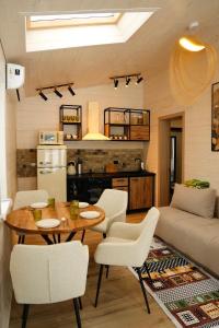 a kitchen and living room with a table and chairs at Легіт in Khashchovanoye