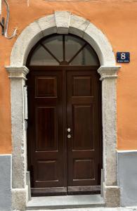 a large wooden door with an arch over it at Torretta International in Trieste