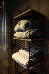 a pile of towels sitting on a shelf at Легіт in Khashchovanoye