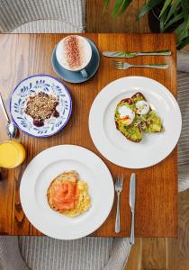 three plates of food on a wooden table at The High Field Town House in Birmingham