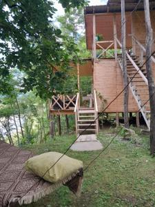 a house with a porch and a swing at Riverside Nature in Martvili