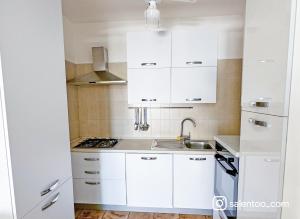 a white kitchen with white cabinets and a sink at SeaBreeze - Torre San Giovanni in Torre San Giovanni Ugento