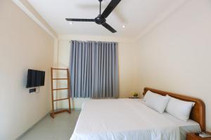 a bedroom with a bed with a ceiling fan at Allude Villa Weligama in Weligama +83 photos