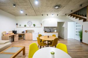 a living room and kitchen with a table and chairs at Birdhouse in Prešov