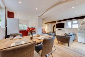 a dining room and living room with a table and chairs at 3 Bed in Croyde oc-yellow in Croyde