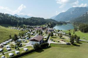 an aerial view of a resort with a lake and mountains at Camping Seehof in Kramsach