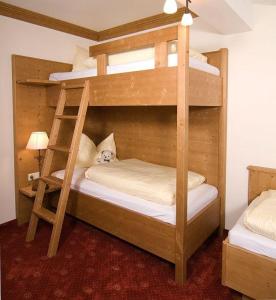 two bunk beds in a room with a cat sitting on them at Camping Seehof in Kramsach
