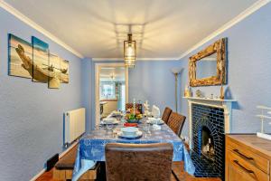 a dining room with a table and a fireplace at 3 Bed in Dawlish oc-c29669 in Dawlish