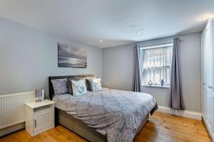 a bedroom with a bed and a window at 3 Bed in Dawlish oc-c29669 in Dawlish