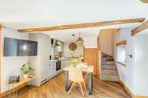 a kitchen and dining room with a table and a staircase at 1 Bed in Bala oc-b27365 in Bala +11 photos