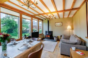a living room with a table and a fireplace at 4 Bed in Satterthwaite oc-c32334 in Grizedale