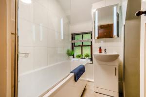 a white bathroom with a tub and a sink at 4 Bed in Satterthwaite oc-c32334 in Grizedale +17 photos