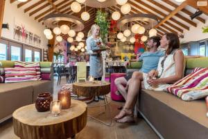 a group of people sitting on couches in a restaurant at Cottage 5p 2Bdrms 16110 in Grupont