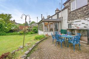 a patio with a table and chairs in front of a building at 4 Bed in Satterthwaite oc-c32334 in Grizedale