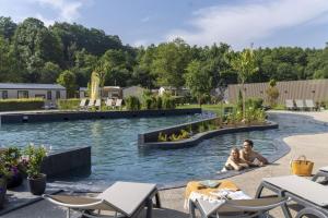 two people sitting in a swimming pool at Cottage 5p 2Bdrms 16110 in Grupont