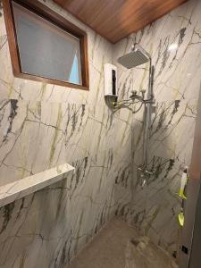 a bathroom with a shower and a sink at Sonnenblume Homestay in General Luna +32 photos