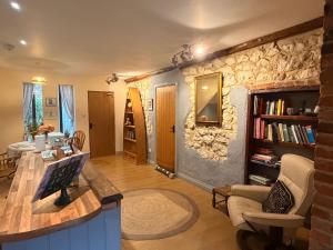 a living room with a stone wall at Old Barn, Beach Farm Hunstanton - Dog Friendly in Heacham
