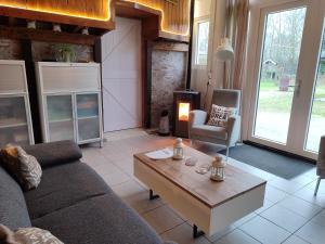 a living room with a couch and a coffee table at B&B Verwoldsehof 'Op de deel' in Laren