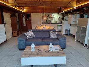 a living room with two couches and a table at B&B Verwoldsehof 'Op de deel' in Laren