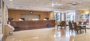 a restaurant with a bar with chairs and a counter at AZ Inn Obu in Obu