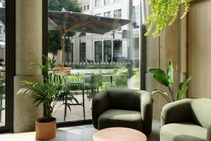 a room with two chairs and a table and a window at People Lyon Hotel in Lyon