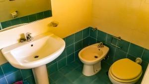 a bathroom with a sink and a toilet at Residence Il Casale in Palinuro