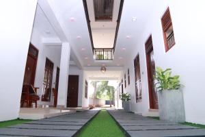 a hallway of a house with a green lawn at Nimjaya holiday bunglow in Anuradhapura +19 photos