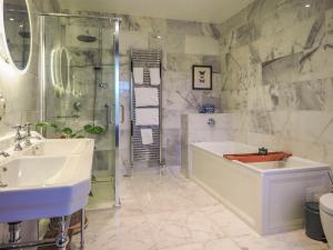 a bathroom with a tub and a shower and a sink at Sancreed House B&B in Penzance