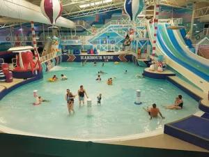 a group of people in an indoor water park at 87 Mountain View, Hafan Y Mor in Afon Wen Junction