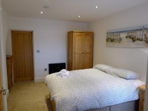 a bedroom with a bed with two bows on it at Church Court Apartments in Rugby