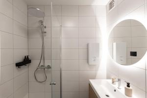 a white bathroom with a shower and a sink at Studio 4 in Bad Schallerbach +79 photos