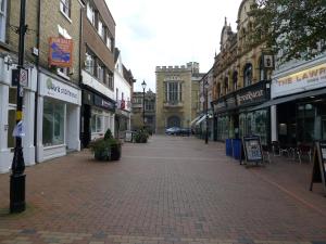 an empty street in a city with buildings at Church Court Apartments in Rugby