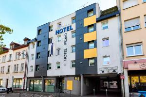 a hotel on the corner of a street at Cit'Hotel Primo Colmar Centre in Colmar