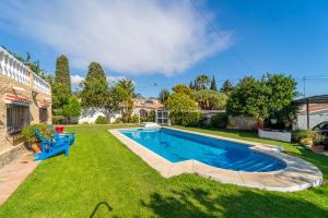 a backyard with a swimming pool and grass at Casa de los Limones by Michael FAMILY VILLA NEAR PUERTO MARINA in Benalmádena +105 photos
