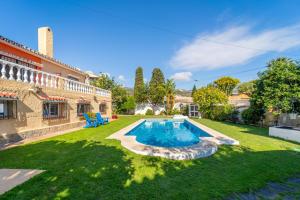 a yard with a swimming pool and a house at Casa de los Limones by Michael FAMILY VILLA NEAR PUERTO MARINA in Benalmádena