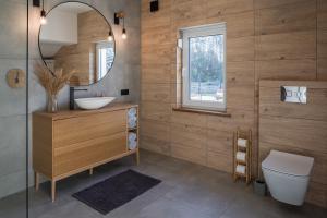 a bathroom with a sink and a mirror at Agroturystyka Milówka in Jagodzin +25 photos