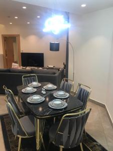 a dining room with a table and chairs at DAMAC Tower Amman boulevard برج داماك - عمان البوليفارد العبدلي in Amman